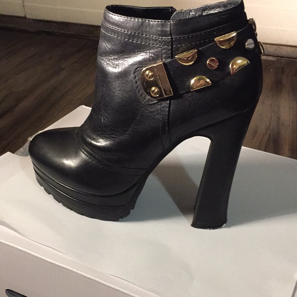 Black leather heeled boots with metallic details